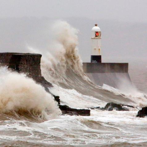 Huge waves crash against the sea wall at Porthcawl, south Wales as Storm Dennis hits the country on February 15, 2020. - As Storm Dennis sweeps in, the country is bracing itself for widespread weather disruption for the second weekend in a row. Experts have warned that conditions amount to a "perfect storm", with hundreds of homes at risk of flooding. (Photo by GEOFF CADDICK / AFP) (Photo by GEOFF CADDICK/AFP via Getty Images)