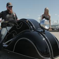 Frazier Hood sitting on hot rod.