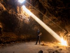 Mojave National Preserve, California: Light rays pass from the surface into the subterannean Cima lava tube.