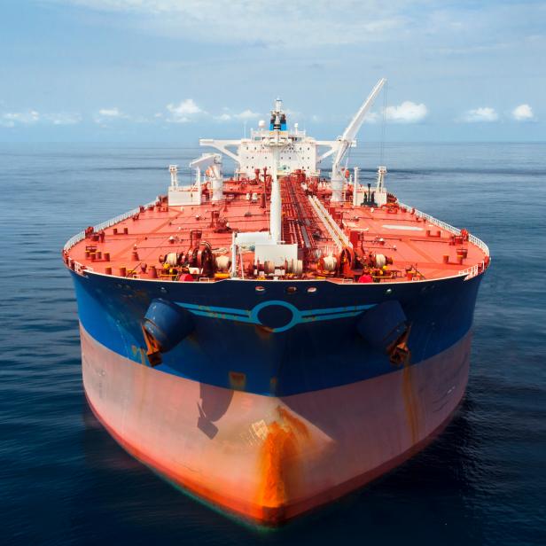 155420181 Aerial photo of a large oil tanker floating in calm seas.