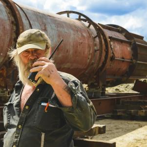 Tony Holding Walkie Talkie in front of the Trommel.