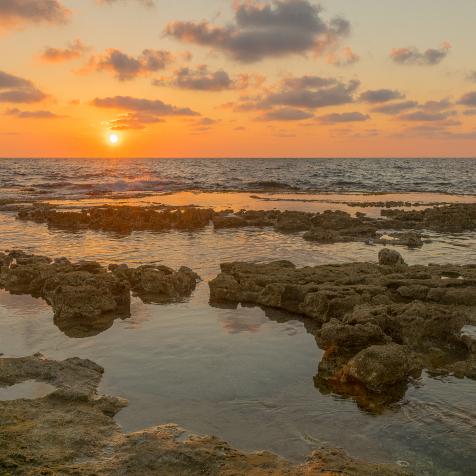 Sunset view of the Mediterranean Sea coast, with abrasion platforms, in Shikmona Park, Haifa, Israel