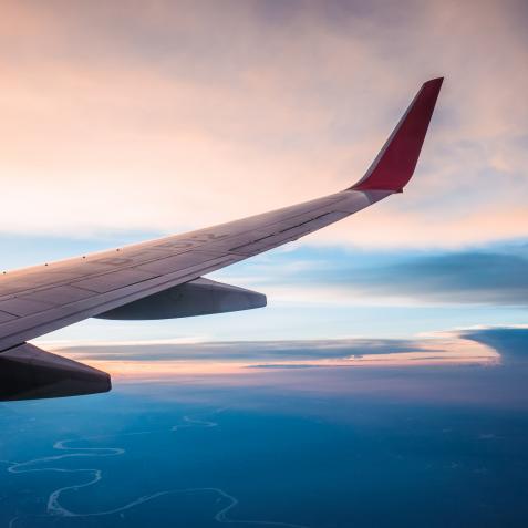Looking Out the Window of a Plane, Pink and Blue Colored Cloudscape.