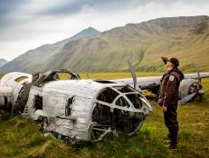 Alaska Maritime National Wildlife Refuge, Aleutian Islands, Alaska: A B-24 bomber, which crashed on Atka Island during World War II.  This is only one of two B-24 bombers to remain in situ since the war. U.S. Fish & Wildlife Service Refuge Chief Steve Delehanty looks toward the sky and flight path the bomber took.