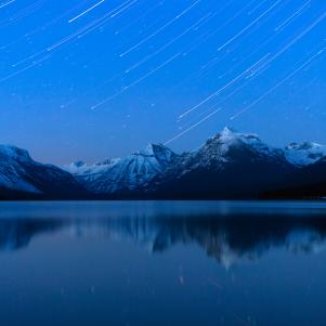 Star trails over Lake McDonald in mid winter in Glacier National Park, Montana.