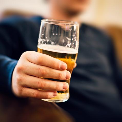 Man drinking pint of beer.
