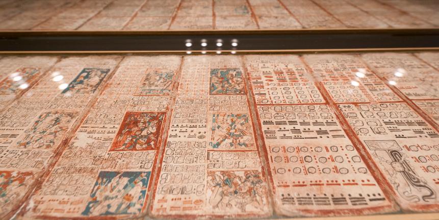 139575312 The historic Maya manuscript 'Codex Dresdensis' is displayed under glass at the museum attached to Saxony's federal library (Saechischen Landesbibliothek) on February 22, 2012 in Dresden, eastern Germany. The 13th century piece is considered one of the world's oldest books. The manuscript was purchased for the museum in Vienna in 1739 as a 'Mexican Book'. It was identified as a Maya manuscript only in 1853. The book is composed of 39 bast fibre pages, which are double-sidedly inscribed and adds up to an overall length of 3.56 metres. The Codex comprises hieroglyphics, numbers and pictures and holds calendars, accounts on stellar constellation, lunar and solar eclipses as well as weather forecasts. Only few of the 750 signs include have been identified so far. The special exhibition "The end of the world in 2012?, The Dresden Maya Code and its deciphering" takes place from 24th of February until 12th of May 2012. AFP PHOTO / ROBERT MICHAEL (Photo credit should read ROBERT MICHAEL/AFP via Getty Images)